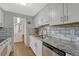 Bright kitchen features white cabinets, granite countertops, stainless steel appliances, and tile backsplash at 364 S Ironton St # 425, Aurora, CO 80012
