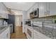 Modern kitchen featuring white cabinets, granite countertops, stainless steel appliances, and subway tile backsplash at 364 S Ironton St # 425, Aurora, CO 80012