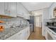 Bright kitchen with white cabinets, granite countertops, stainless steel appliances, and subway tile backsplash at 364 S Ironton St # 425, Aurora, CO 80012