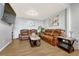 Cozy living room featuring comfortable brown leather sofas, modern decor, and a wall-mounted TV at 364 S Ironton St # 425, Aurora, CO 80012