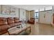 Comfortable living room with leather sofa, accent chair, and a stone-accented wall, offering a cozy atmosphere at 364 S Ironton St # 425, Aurora, CO 80012