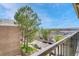 A balcony view overlooking a tree-lined street and parking lot, showcasing the property's surroundings at 364 S Ironton St # 425, Aurora, CO 80012