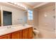 Bathroom with double vanity and glass block window at 1225 Briarhollow Way, Highlands Ranch, CO 80129