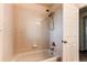 Clean bathroom with shower/tub combo and tile surround at 1225 Briarhollow Way, Highlands Ranch, CO 80129