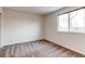 Simple bedroom with large window and carpet at 1225 Briarhollow Way, Highlands Ranch, CO 80129