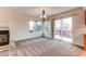 Dining area with fireplace, carpet flooring, and access to deck at 1225 Briarhollow Way, Highlands Ranch, CO 80129