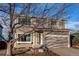 Two-story house with attached garage and mature tree in front at 1225 Briarhollow Way, Highlands Ranch, CO 80129