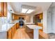 Kitchen with island, wood cabinets, and stainless steel appliances at 1225 Briarhollow Way, Highlands Ranch, CO 80129