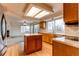 Kitchen with island, wood cabinets, and stainless steel appliances at 1225 Briarhollow Way, Highlands Ranch, CO 80129