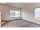 Bright living room with carpet flooring and large window at 1225 Briarhollow Way, Highlands Ranch, CO 80129