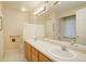 Bathroom boasts double sinks, large mirror and a bathtub at 23619 Genesee Village Rd # B, Golden, CO 80401