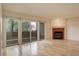 Living room with hardwood floors, fireplace and sliding doors to balcony at 23619 Genesee Village Rd # B, Golden, CO 80401