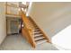 Bright, airy stairwell with wood railings and carpeted flooring at 23619 Genesee Village Rd # B, Golden, CO 80401