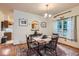 Cozy dining room with classic wood furniture, hardwood floors, and a view into the kitchen at 218 E Colorado Ave, Berthoud, CO 80513