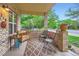 Cozy covered porch with seating, brick columns, and a view of the neighborhood at 218 E Colorado Ave, Berthoud, CO 80513