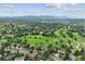 Scenic aerial view of a lush, green community with a golf course and mountain views at 11621 Shoshone Way, Denver, CO 80234