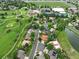 Aerial view showing neighborhood amenities including a pool, tennis courts, golf course, and nearby pond at 11621 Shoshone Way, Denver, CO 80234