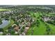 Neighborhood aerial showcasing green spaces, tree-lined streets, and community layout near a golf course at 11621 Shoshone Way, Denver, CO 80234