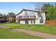 The back exterior features a multi-level deck, large windows, and a well-maintained lawn at 11621 Shoshone Way, Denver, CO 80234