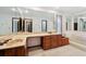 Bathroom featuring a large vanity with double sinks and ample storage, a bathtub, and a large mirror at 11621 Shoshone Way, Denver, CO 80234