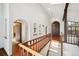 Hallway features arched doorways, built-in shelving, and a wooden staircase at 11621 Shoshone Way, Denver, CO 80234