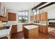 Kitchen with tile floors, island, oak cabinets, and large windows with golf course view at 11621 Shoshone Way, Denver, CO 80234