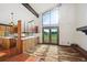 Kitchen with island, oak cabinets, tile floors, and large windows with natural light at 11621 Shoshone Way, Denver, CO 80234