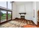 Living room boasting a fireplace, large windows, and access to the balcony at 11621 Shoshone Way, Denver, CO 80234