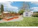 Backyard with a gray shed and raised garden beds, perfect for gardening and outdoor storage needs at 6188 S Westview St, Littleton, CO 80120