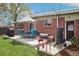 Backyard patio featuring a dining set and grills, creating an ideal space for outdoor cooking and entertaining guests at 6188 S Westview St, Littleton, CO 80120