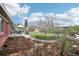 Expansive backyard features a dining patio, outdoor seating, lush greenery, and convenient storage shed at 6188 S Westview St, Littleton, CO 80120