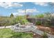Landscaped backyard with a gravel area, a fire pit, and seating for gathering outdoors at 6188 S Westview St, Littleton, CO 80120