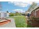 Spacious backyard featuring a shed, raised garden beds, grassy area, and patio with outdoor dining at 6188 S Westview St, Littleton, CO 80120