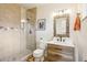 The bathroom features a glass-enclosed shower, vanity, and modern fixtures for a luxurious experience at 6188 S Westview St, Littleton, CO 80120