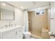 Tiled bathroom with modern vanity and large walk-in shower offering a clean, stylish aesthetic at 6188 S Westview St, Littleton, CO 80120