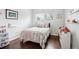 Light-filled bedroom with hardwood floors, a twin bed, and window, creating a cozy and inviting space at 6188 S Westview St, Littleton, CO 80120