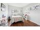 Bright bedroom with wood floors, a decorative window and updated furnishings at 6188 S Westview St, Littleton, CO 80120