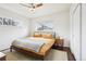 Cozy bedroom with a comfortable bed, two windows, and ceiling fan, offering a serene retreat at 6188 S Westview St, Littleton, CO 80120