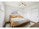 Comfortable bedroom featuring a ceiling fan, double windows for natural light, and a closet for ample storage at 6188 S Westview St, Littleton, CO 80120