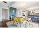 Dining area with open layout flows into the modern kitchen with a breakfast bar and stylish lighting at 6188 S Westview St, Littleton, CO 80120