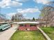 Charming brick home with a well-manicured lawn, covered garage, and inviting walkway leading to the entrance at 6188 S Westview St, Littleton, CO 80120