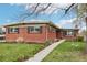 Charming brick home featuring a manicured lawn, quaint walkway, and mature landscaping at 6188 S Westview St, Littleton, CO 80120