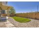 A fenced yard with small patch of green artificial turf and landscaping stones surrounding it at 3130 Hardin St, Castle Rock, CO 80109