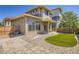 Back exterior of home featuring fenced yard, artificial turf, sliding glass doors and gravel landscaping at 3130 Hardin St, Castle Rock, CO 80109