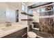 Stylish bathroom features dark-tiled shower with glass door, floating shelves, and modern fixtures at 3130 Hardin St, Castle Rock, CO 80109