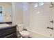 This bathroom features a dark vanity, a toilet, a bathtub, and a shower with white subway tile at 3130 Hardin St, Castle Rock, CO 80109