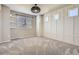 Cozy bedroom with a statement light fixture, and large windows providing natural light at 3130 Hardin St, Castle Rock, CO 80109