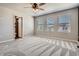 Spacious bedroom features a ceiling fan, three windows, and closet access at 3130 Hardin St, Castle Rock, CO 80109