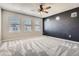 Inviting bedroom with plush carpeting, a ceiling fan, and three sunlit windows at 3130 Hardin St, Castle Rock, CO 80109