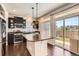 Modern kitchen featuring stainless steel appliances, a central island, and backyard access at 3130 Hardin St, Castle Rock, CO 80109